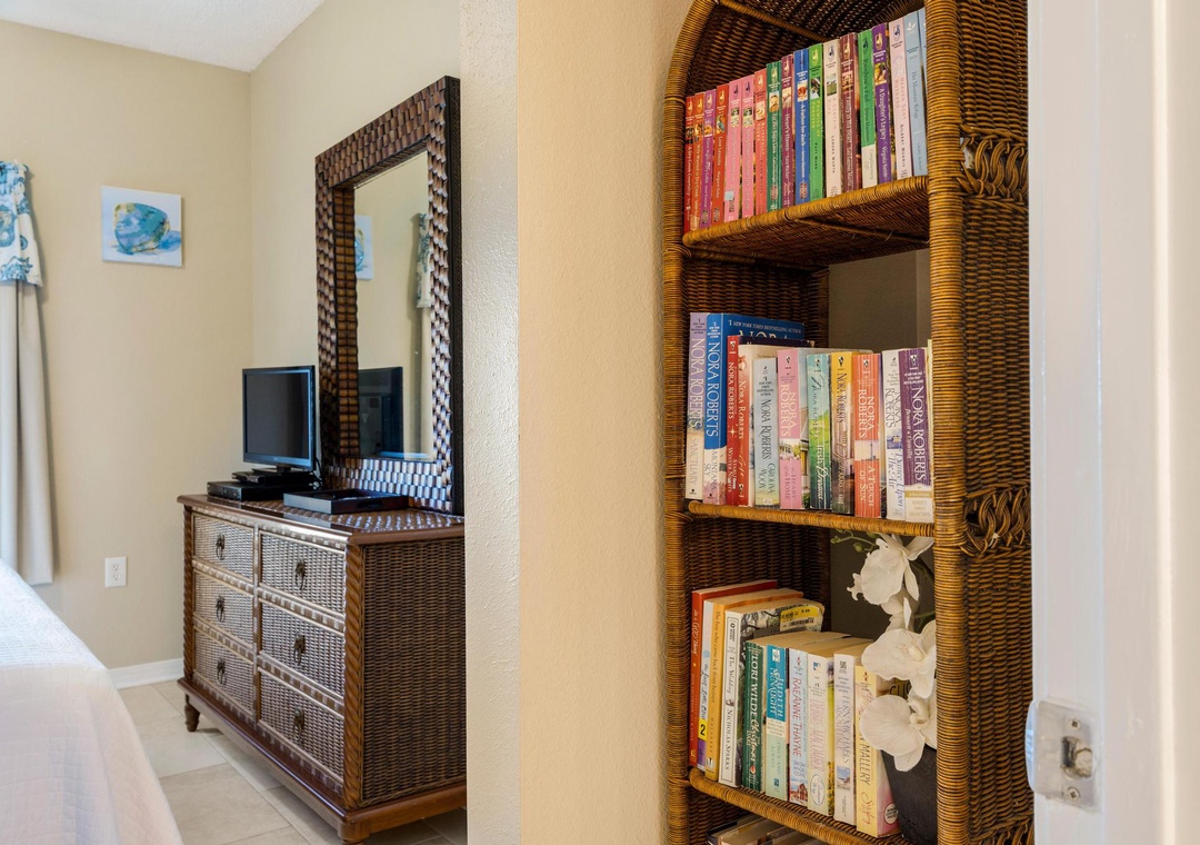 Guest bedroom featuring a stocked bookshelf
