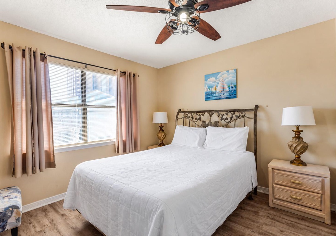 Primary bedroom with a queen bed and ceiling fan