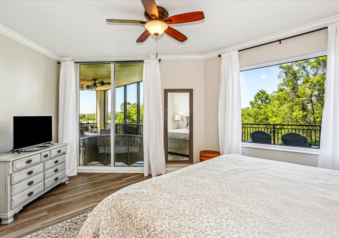 King primary bedroom with balcony access