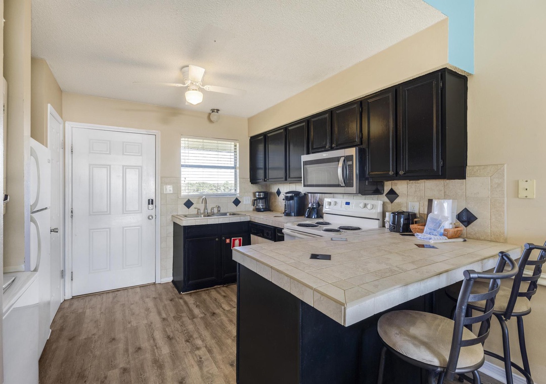 Kitchen with stainless microwave and electric range