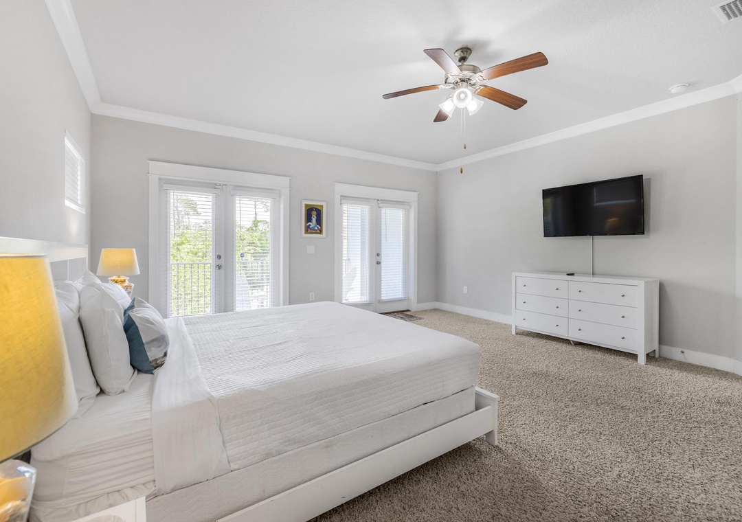 King primary bedroom with private balcony