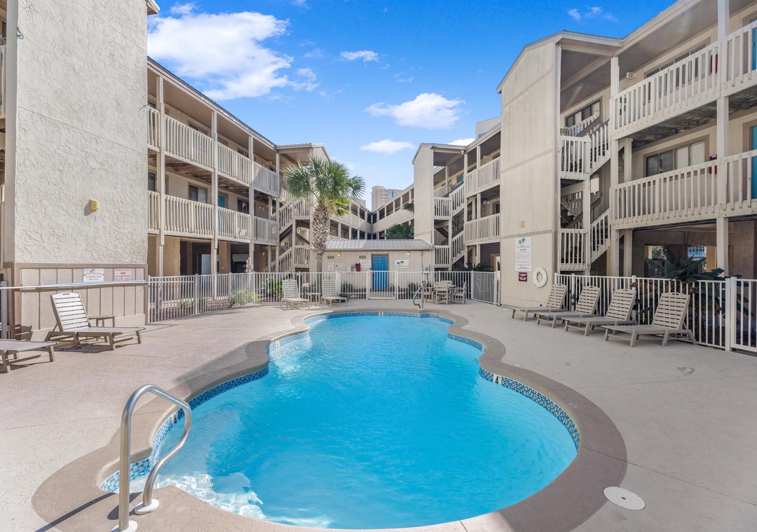 Community pool with lounge chairs