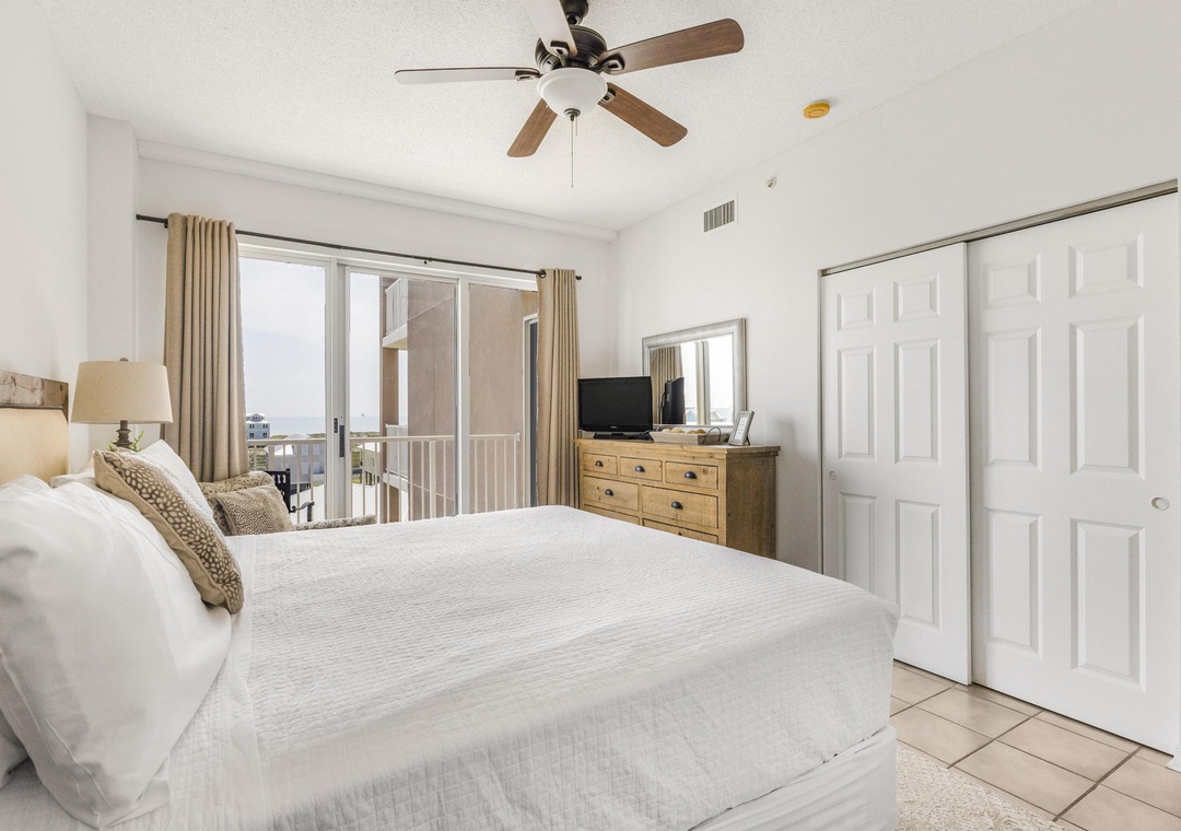 King primary bedroom with balcony access