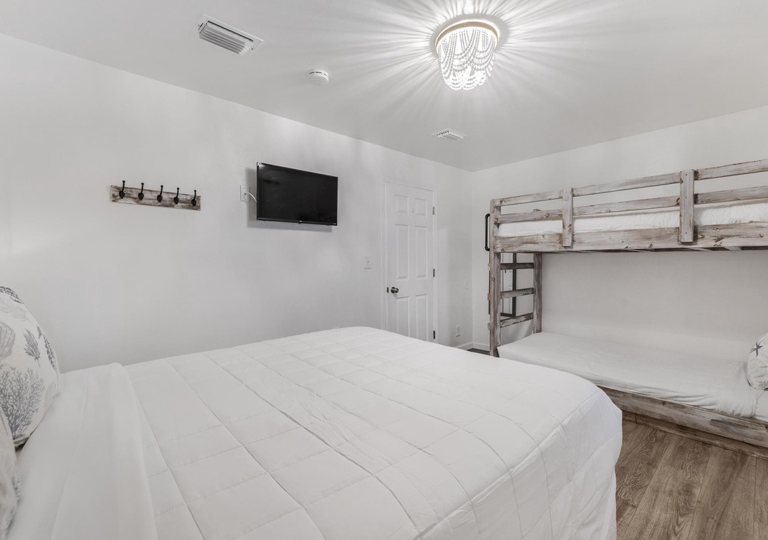 Queen bed and bunk beds in the bedroom