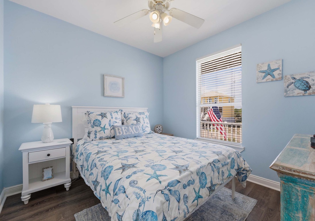 Main level guest bedroom with queen bed