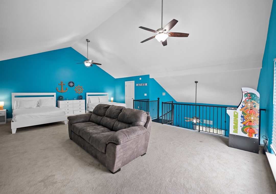 Loft space with sofa and two queen beds