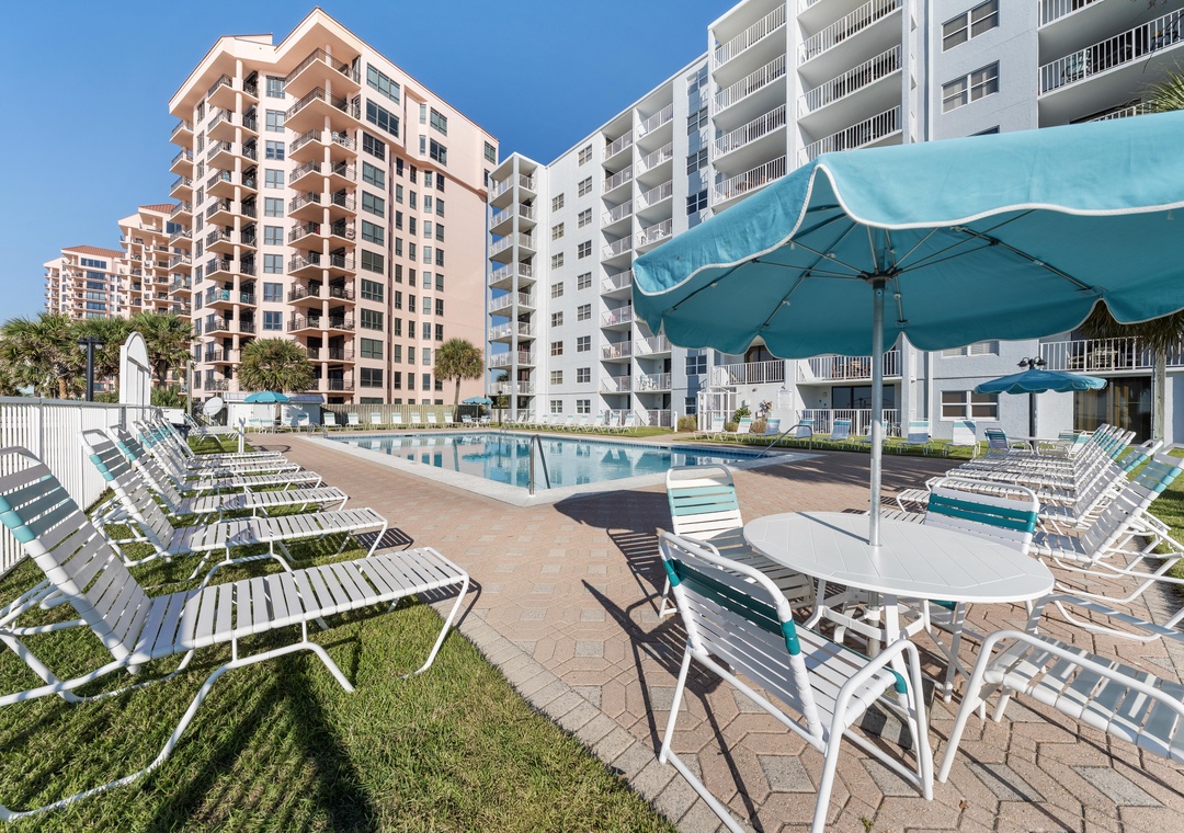 Poolside tables with umbrellas