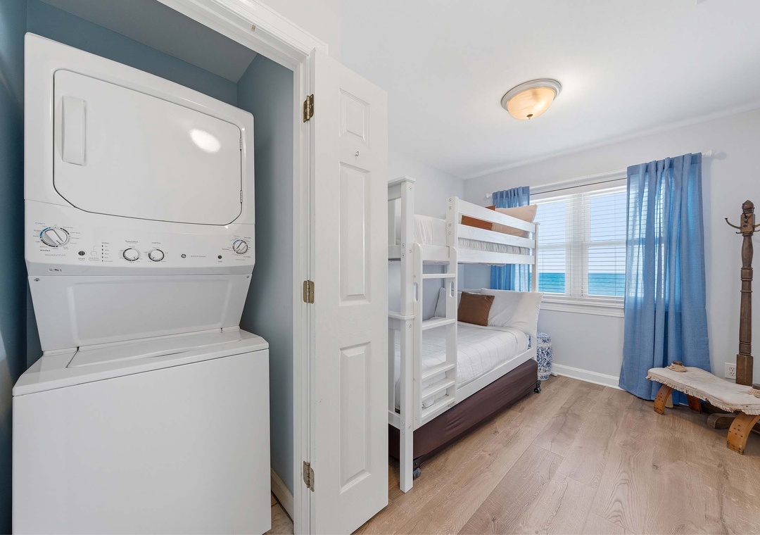Upstairs common area with twin-over-twin bunk bed and in-unit laundry
