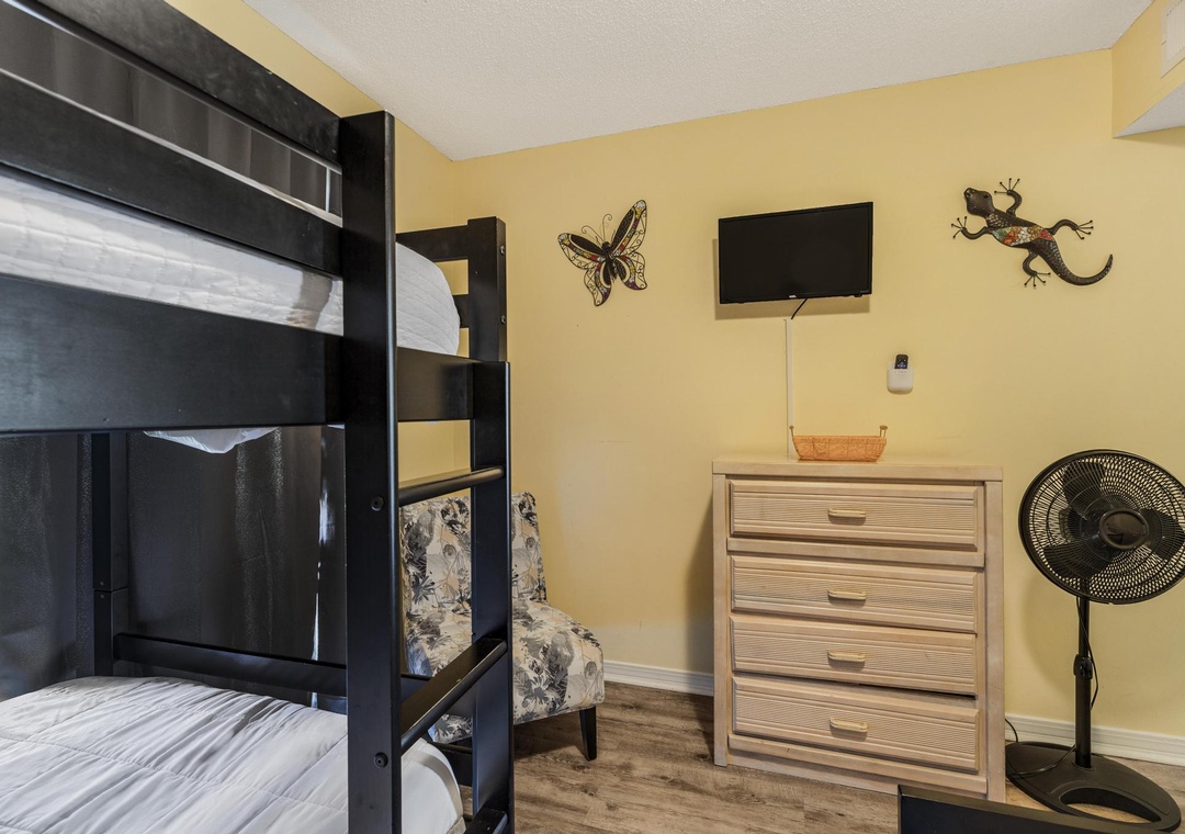 Guest bedroom with dresser and TV