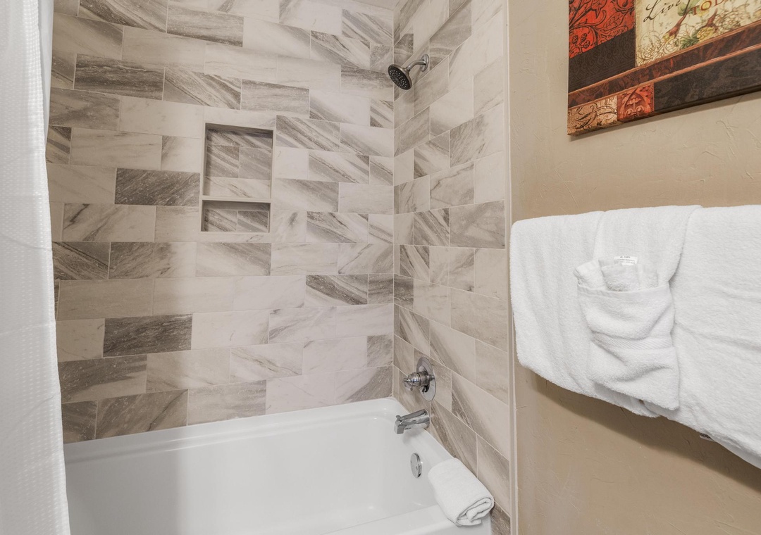 Guest bathroom with tiled shower/tub combo