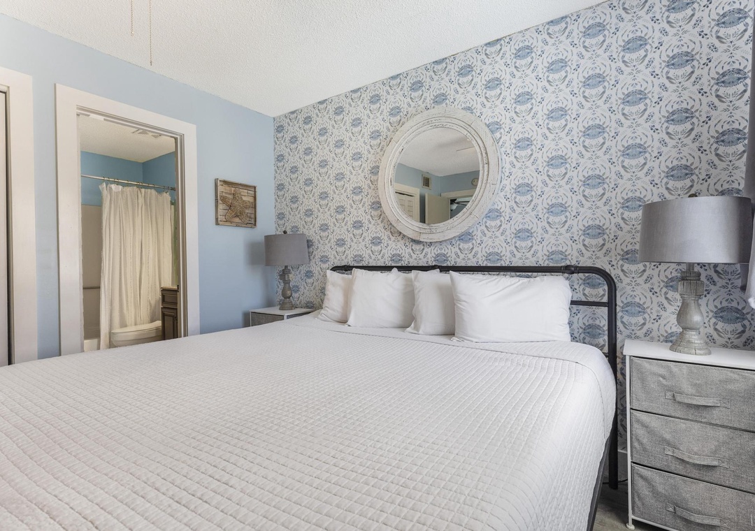 Primary bedroom with accent wallpaper
