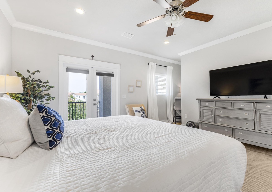 Primary bedroom with balcony access