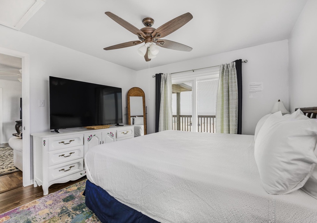 Large flat-screen TV in the primary bedroom