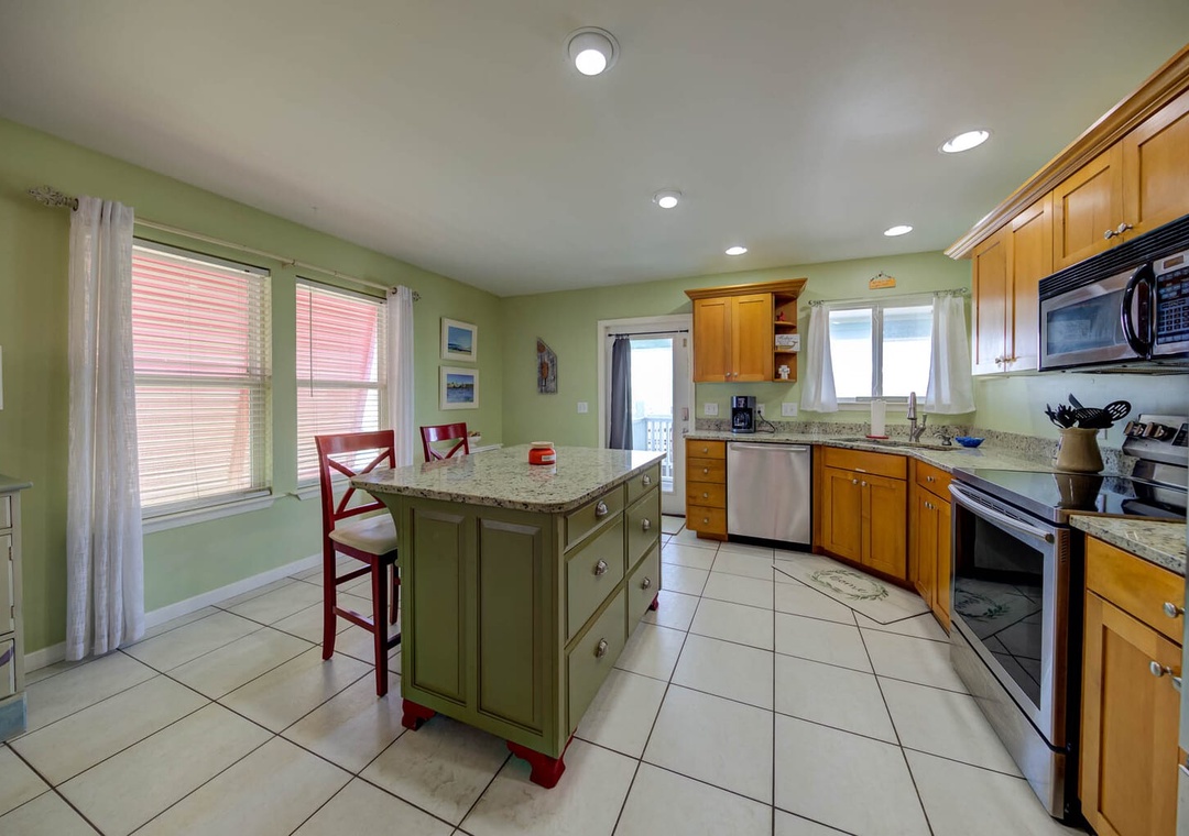 Well-equipped kitchen stocked with pots/pans/utensils.