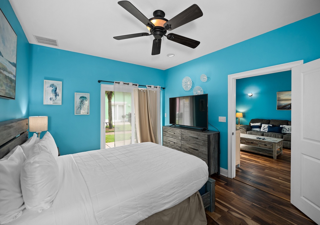 Queen primary bedroom with direct patio access