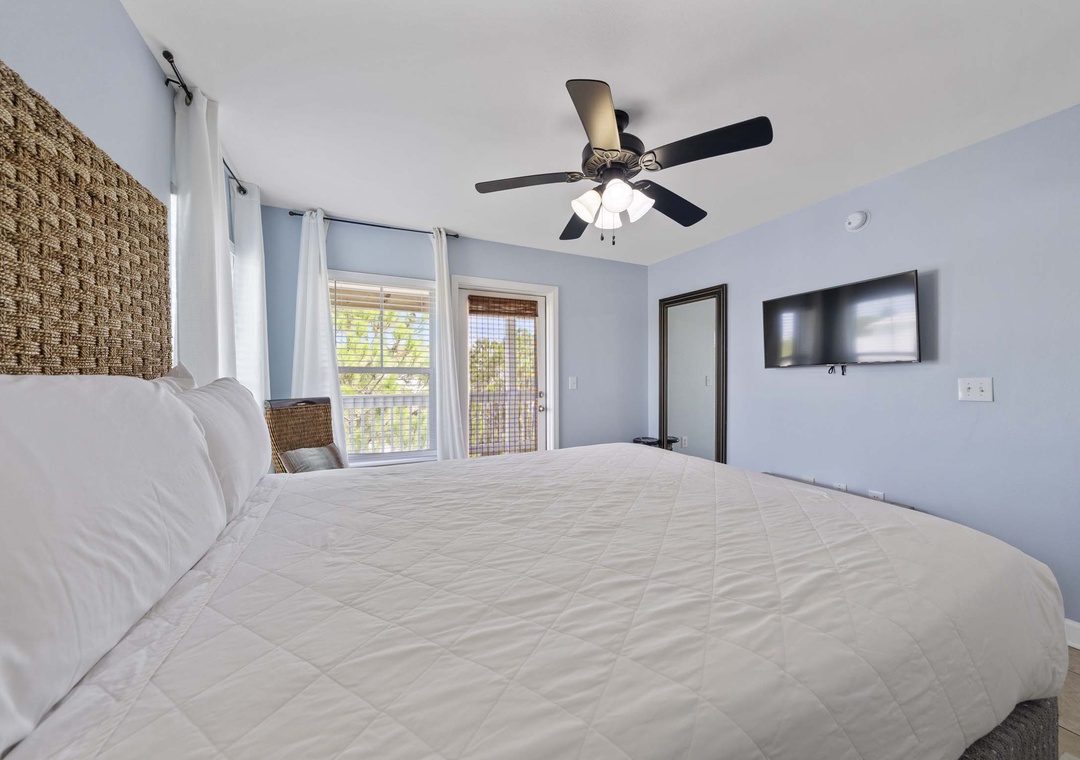 Queen bed and balcony access in guest bedroom 3