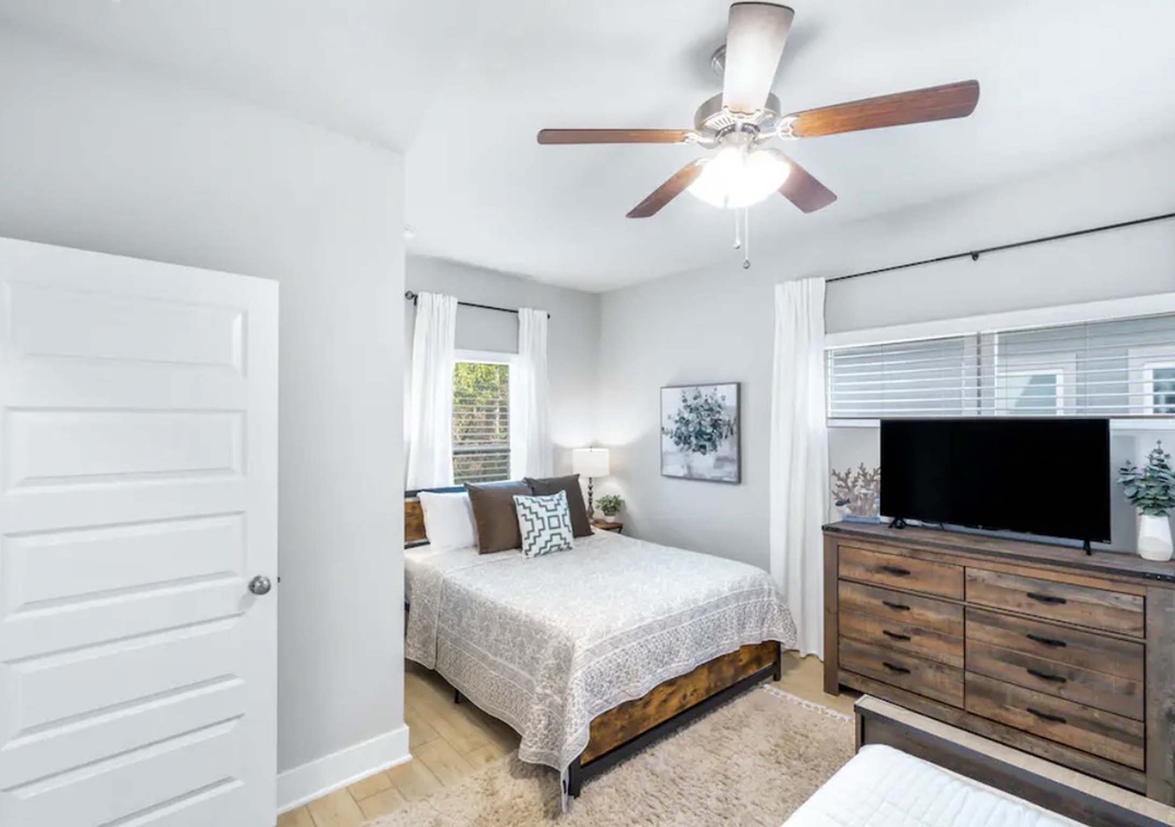 First floor guest bedroom 3 with queen bed and jack & jill bathroom