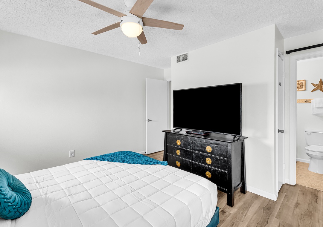 King bedroom with large flat-screen TV