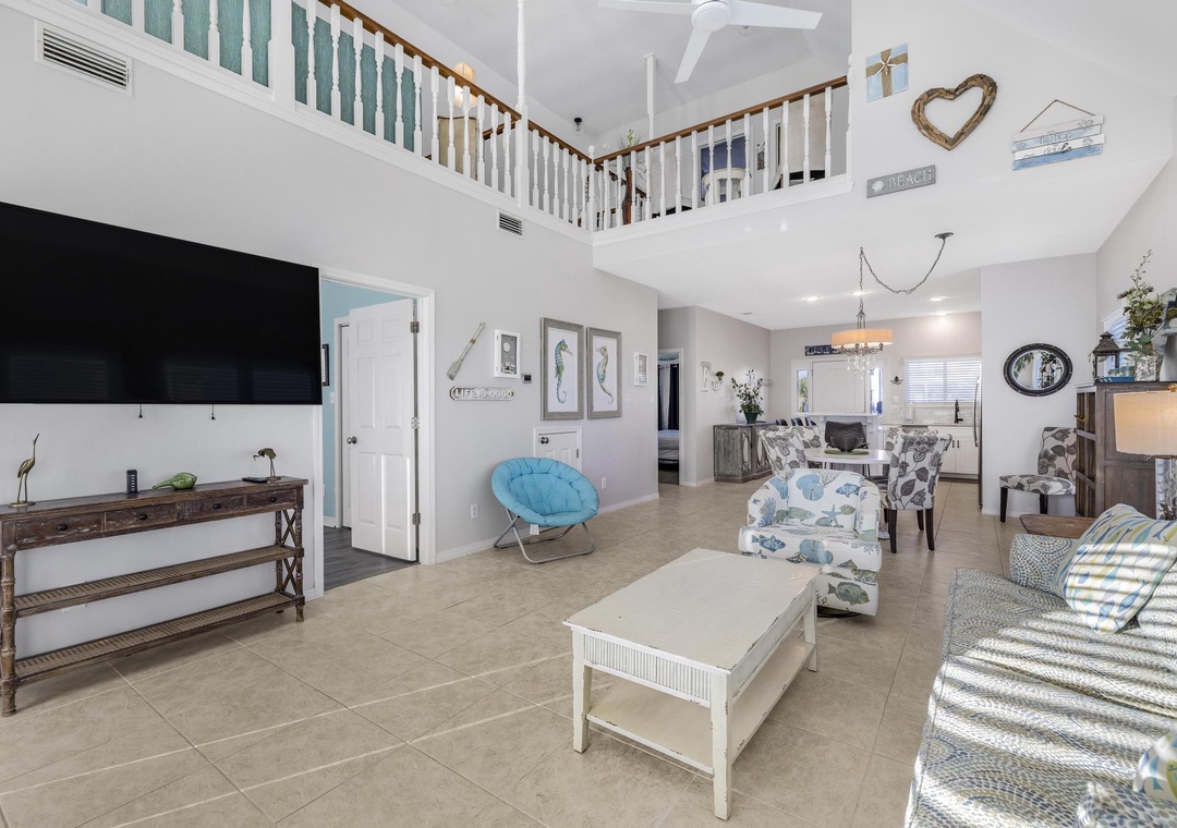 Living room with high ceilings and a large flat-screen TV