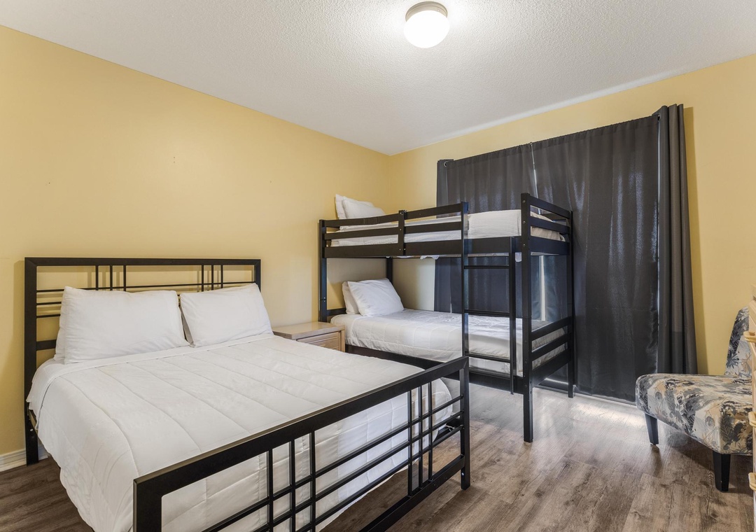 Guest bedroom with a double bed and twin-over-twin bunk bed
