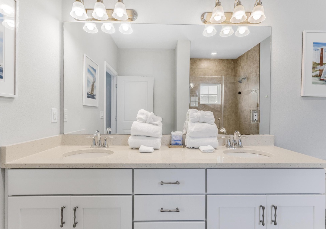 Primary ensuite bathroom with dual vanities