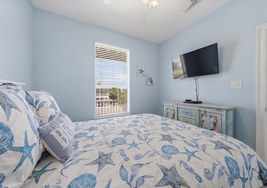 Main level guest bedroom with queen bed