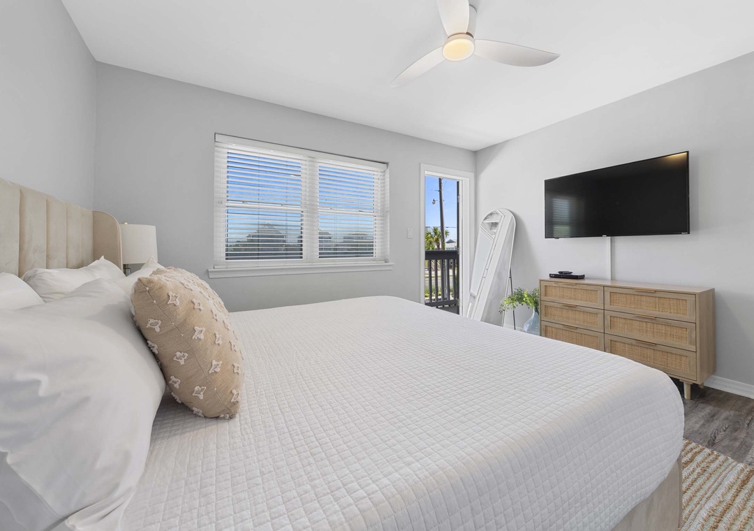 Primary bedroom with balcony access