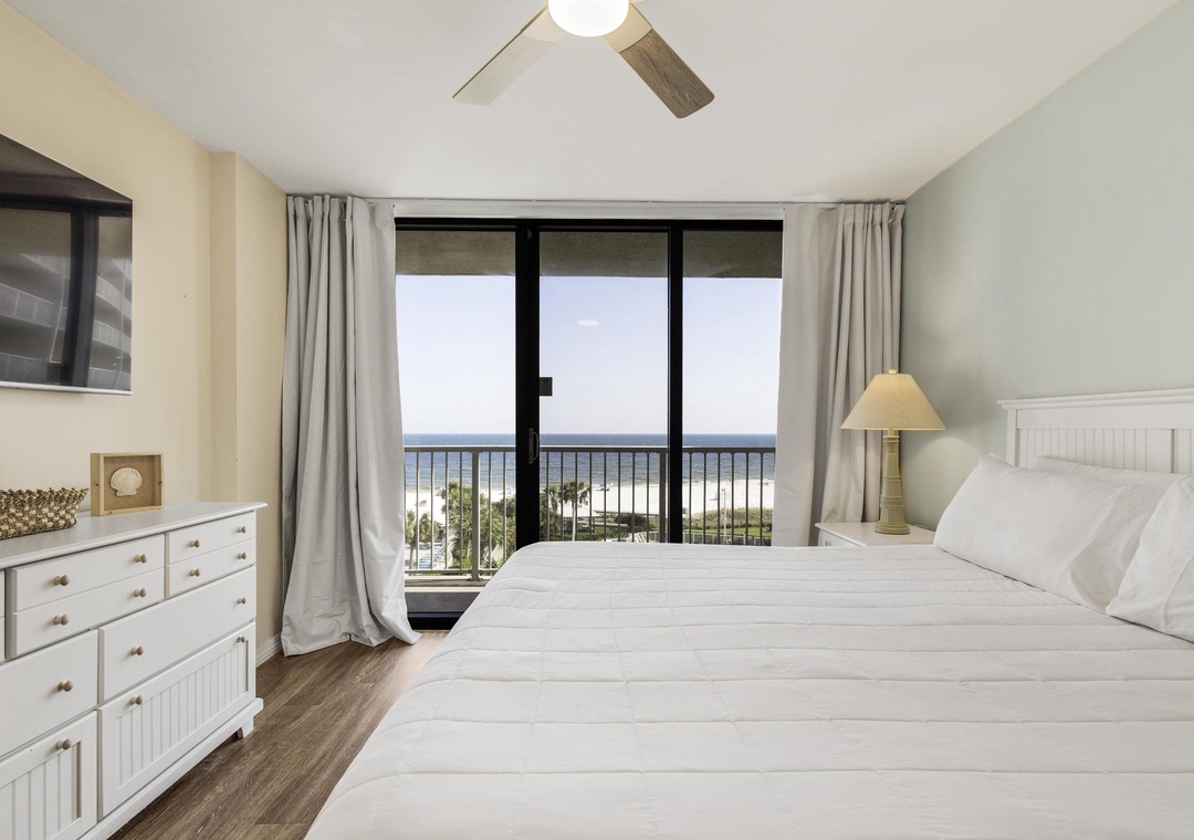 King primary bedroom with balcony access