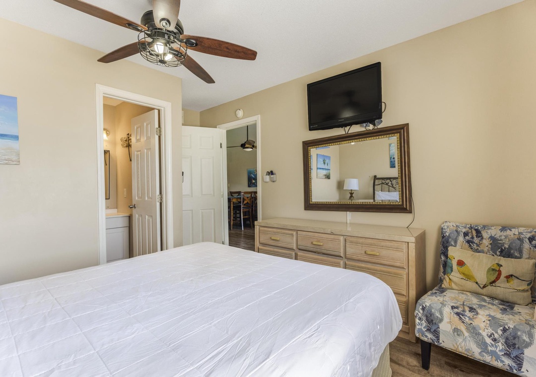 Primary bedroom with dresser and TV