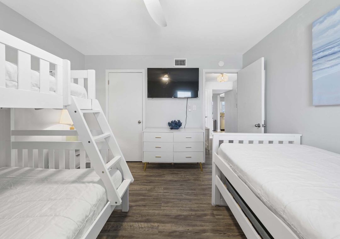 Guest bedroom with twin-over-full bunk bed and twin bed with twin trundle