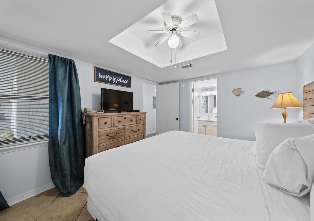 Primary bedroom with TV and ensuite access