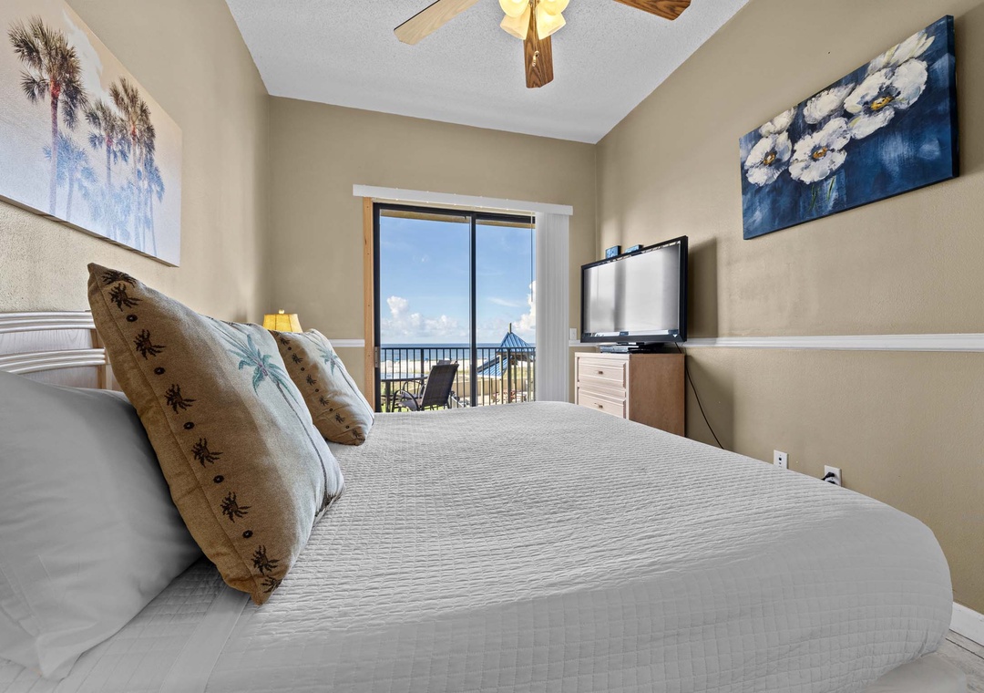 King primary bedroom with balcony access