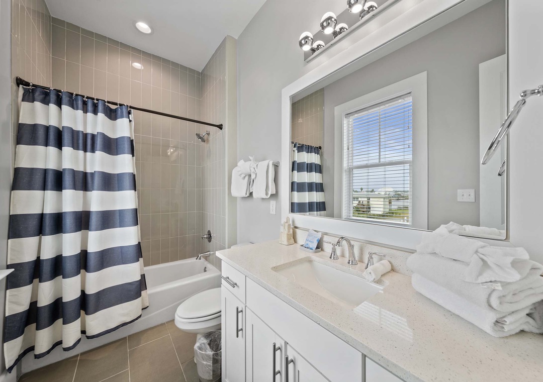 Main floor guest bathroom with shower/tub combo