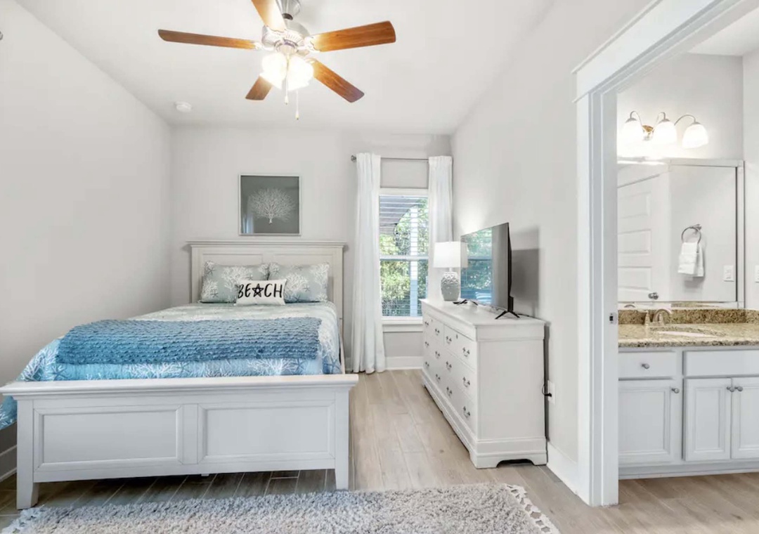 First floor guest bedroom 2 with queen bed and jack & jill bathroom
