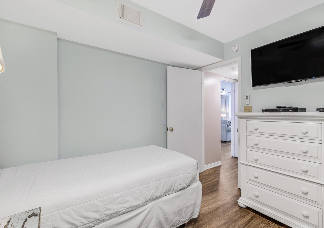 Guest bedroom with mounted flat-screen TV