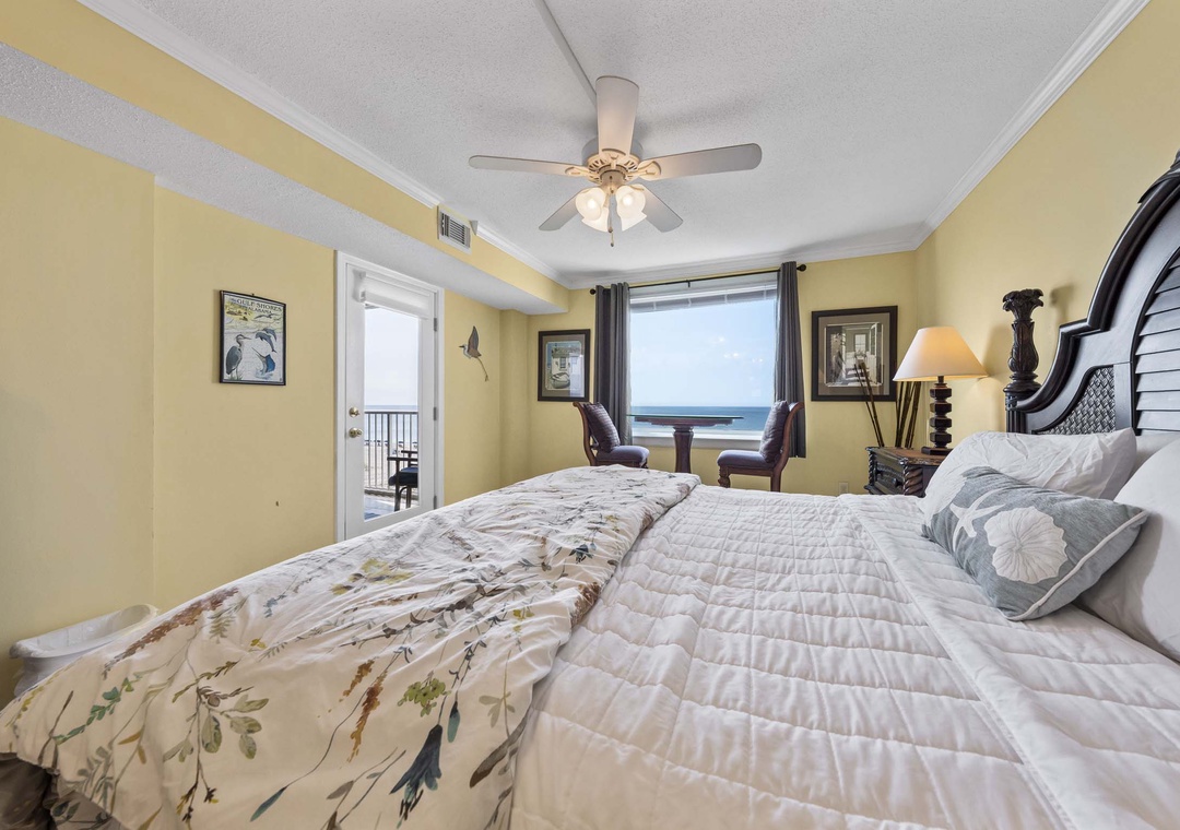 Primary bedroom with king bed and balcony access
