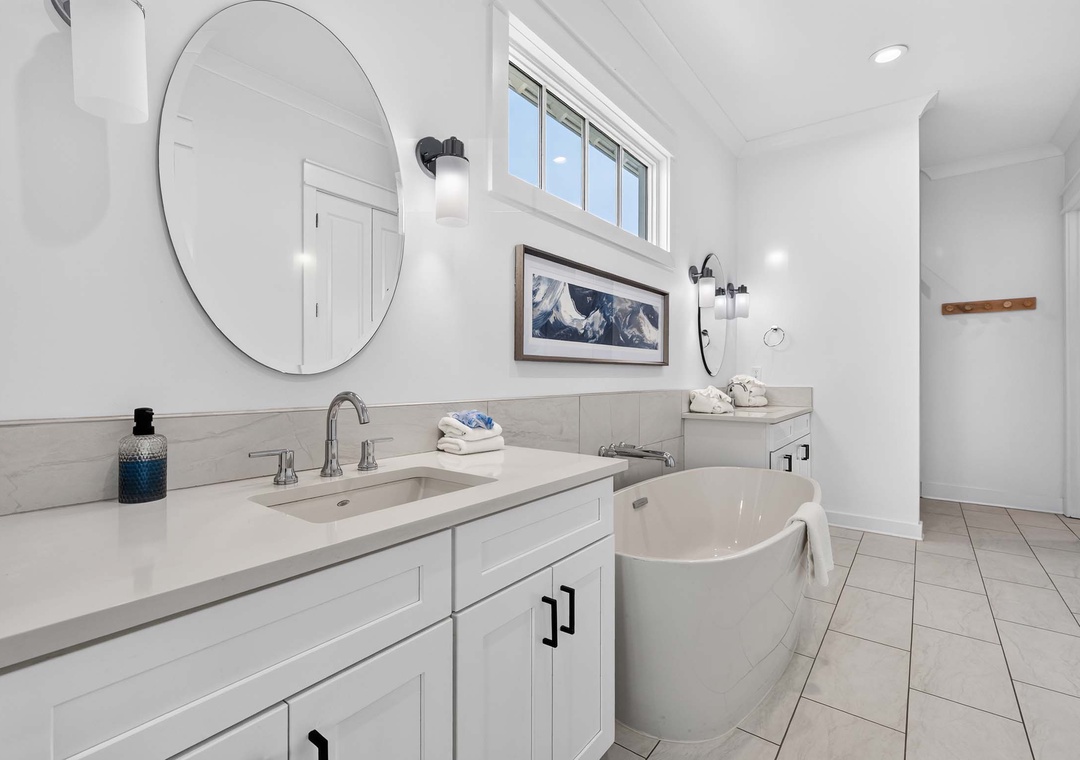 Primary ensuite bathroom featuring a soaking tub