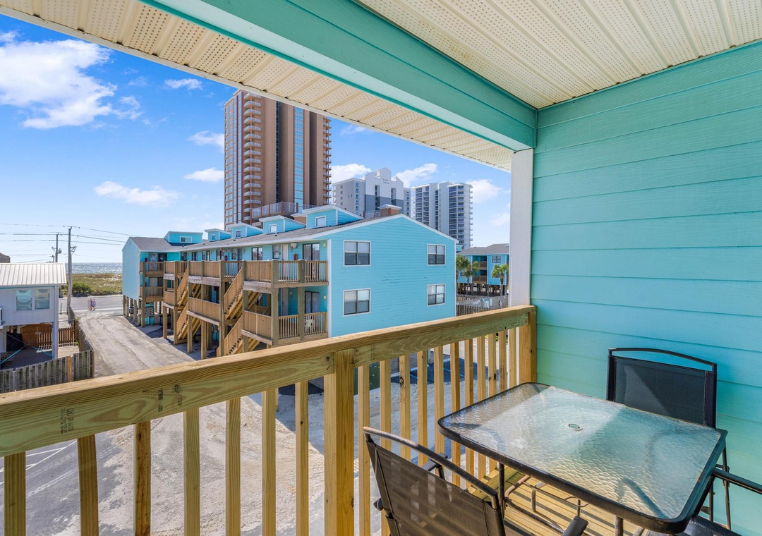 Private balcony with outdoor dining and a peek of the Gulf