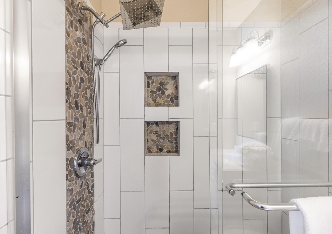 Walk-in shower with rain showerhead and handheld sprayer