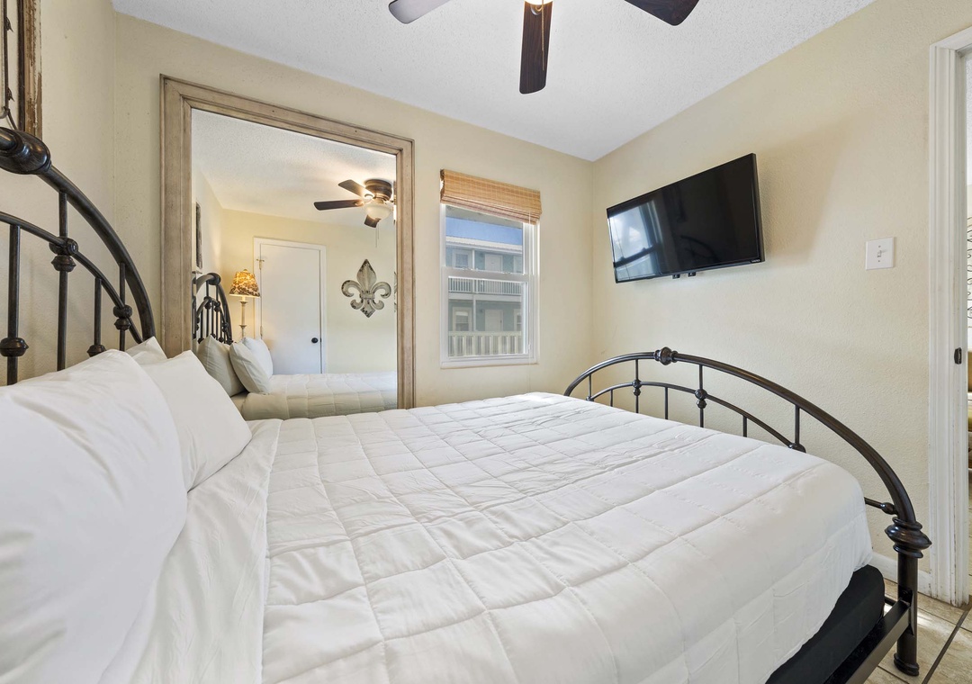 Queen bedroom 1 with mounted flat-screen TV