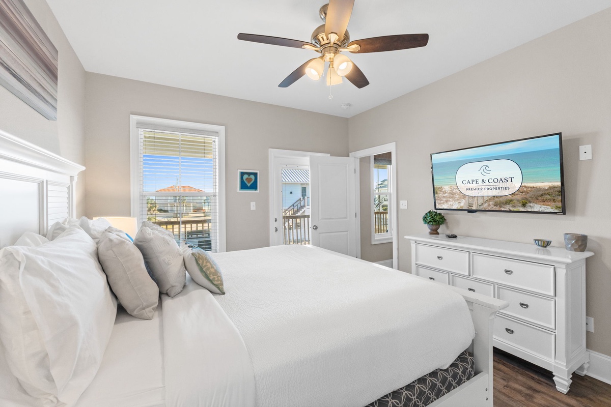 Wake up to waterfront views in your serene master bedroom, where soft linens and coastal elegance create the perfect retreat.