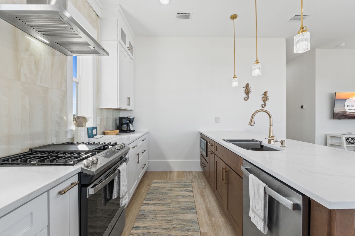 Your gourmet kitchen features marble countertops, professional appliances, and elegant pendant lighting—perfect for crafting memorable meals during your stay.