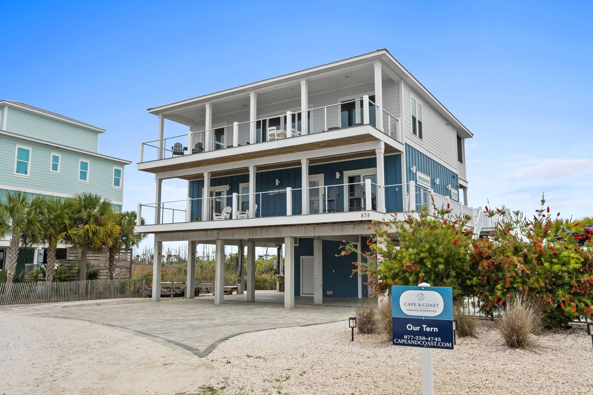 Modern beachfront home with elevated design and multiple balconies overlooking pristine coastal surroundings.