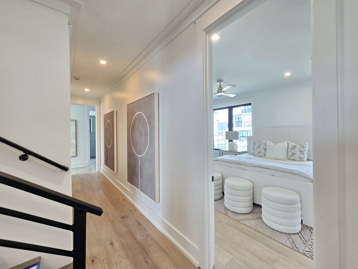 Step into your serene bedroom sanctuary with plush seating, city views, and contemporary design that invites relaxation.