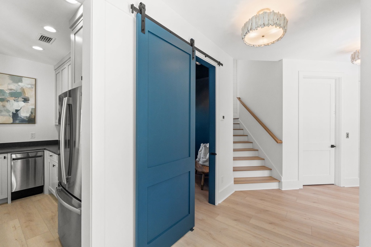 Step into your stylish retreat where modern barn doors add character to bright, open spaces with gleaming hardwood floors.