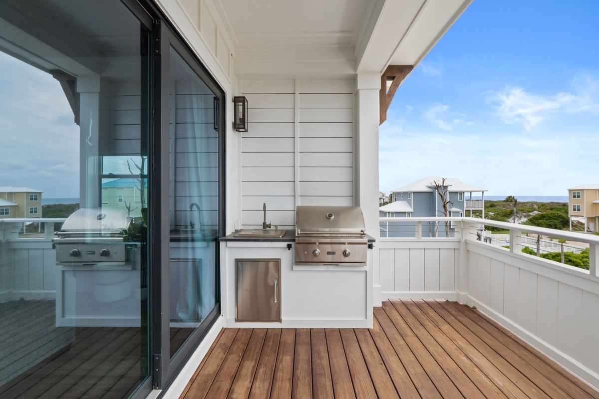 Your private balcony features a built-in grill and sink, perfect for outdoor cooking while taking in coastal views and ocean breezes.