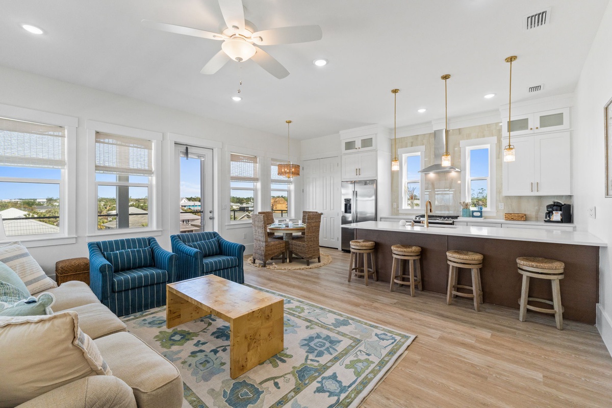 Unwind in this bright, open-concept space where your living room flows seamlessly into a fully equipped kitchen with breakfast bar seating.
