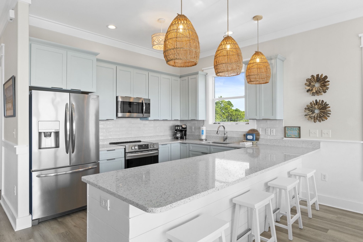 Your dream kitchen awaits with gleaming granite counters, stainless steel appliances, and coastal pendant lights creating the perfect space for memorable meals.