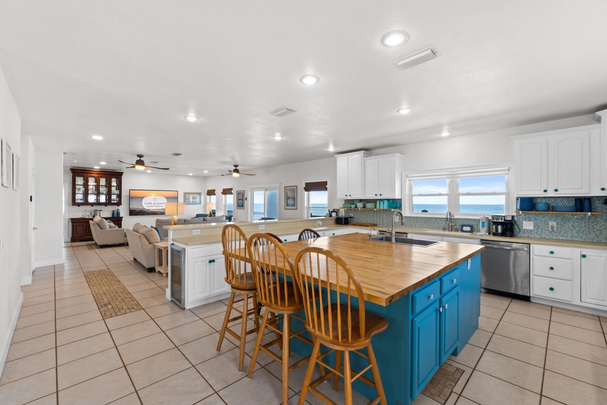 Gather around this spacious kitchen island where cooking becomes a shared experience. With ocean views and plenty of room to prep meals together, your beach vacation starts here.