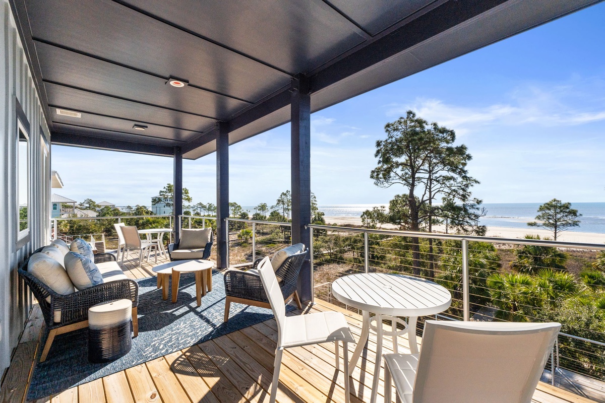 Relax on your private covered balcony with stunning sea views, comfortable seating, and gentle ocean breezes.